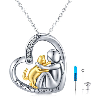 Heart-shaped pendant with gold cat and silver woman, 'Keep me in your heart' text, with tools on a white background