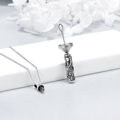 Silver necklace with a detailed pendant on a white surface with a floral background