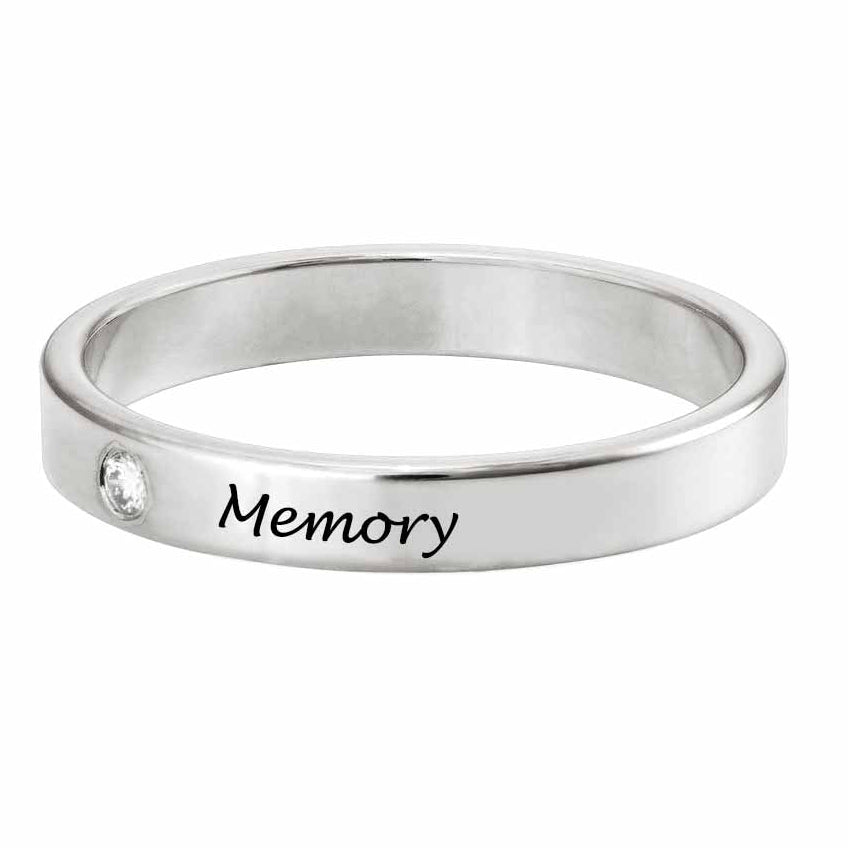 Silver ring with 'Memory' engraving on a white background