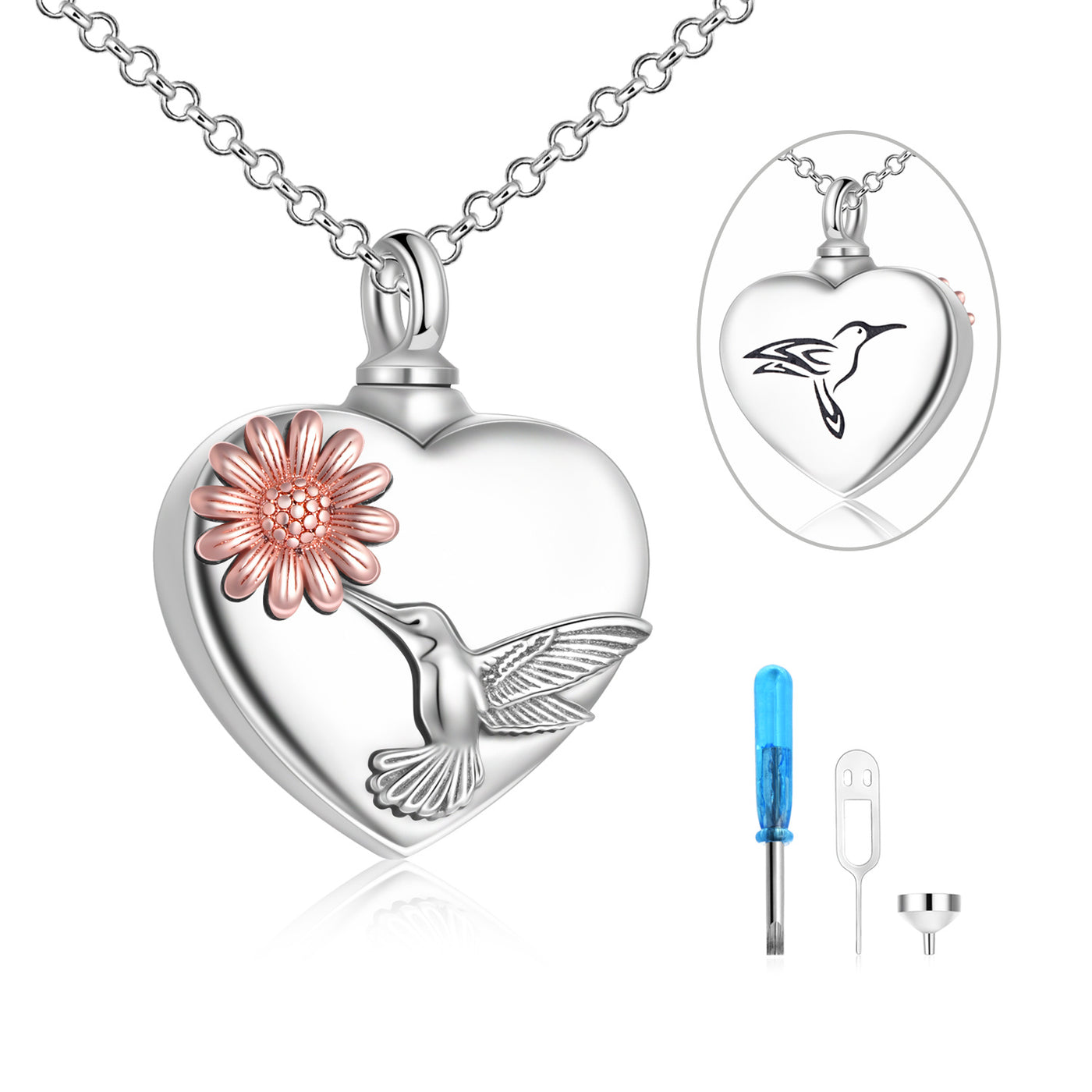 Heart-shaped silver pendant with a flower and bird design, including a close-up inset and tools on a white background.