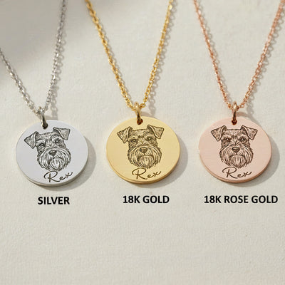 Three engraved pet portrait necklaces displayed side by side in silver, 18K gold, and rose gold finishes, each featuring a dog illustration and name engraving.