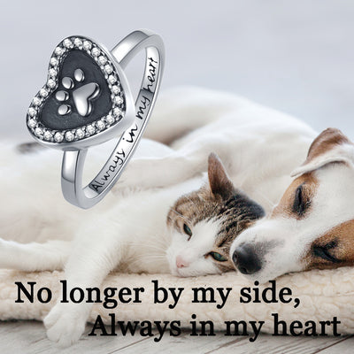 Silver ring with paw print design on a cat and dog lying together, with text 'No longer by my side, Always in my heart'.