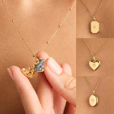 Gold necklaces with various pendants on a brown background