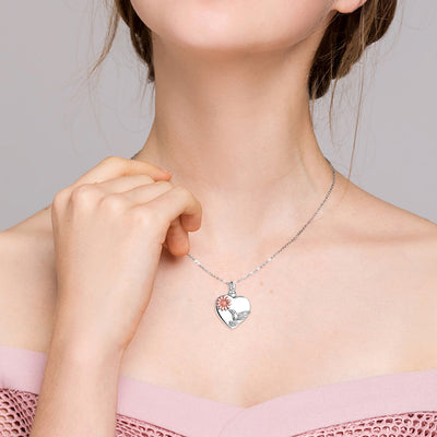 Heart-shaped necklace with a pendant worn by a model against a neutral background