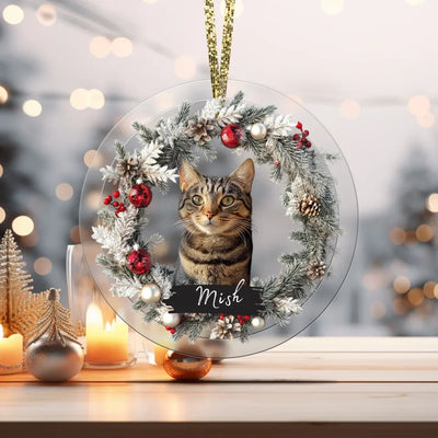 Circular glass ornament featuring a pet photo, surrounded by festive holiday decorations, perfect as a personalized memorial keepsake.