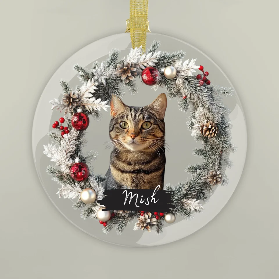 Circular glass ornament featuring a pet photo, surrounded by festive holiday decorations, perfect as a personalized memorial keepsake.