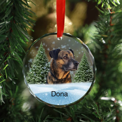 Glass ornament featuring a photo of a dog, surrounded by a winter forest scene, ideal as a pet memorial keepsake