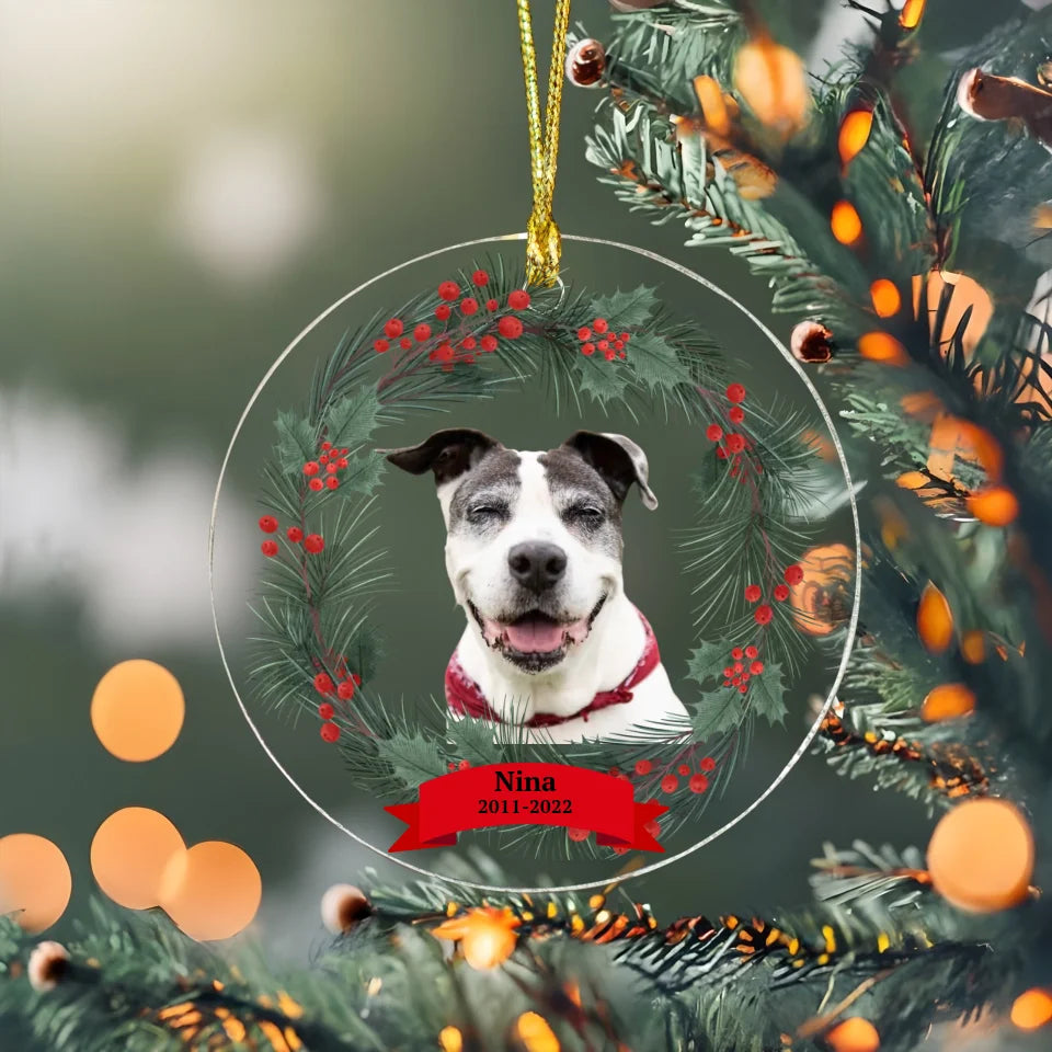 Circular ornament with evergreen accents and a pet photo, perfect as a personalized pet memorial and holiday keepsake