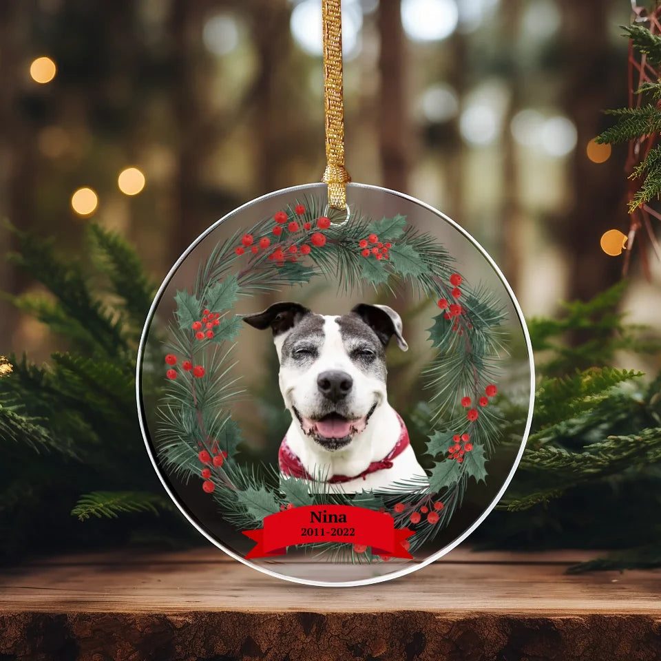 Circular ornament with evergreen accents and a pet photo, perfect as a personalized pet memorial and holiday keepsake