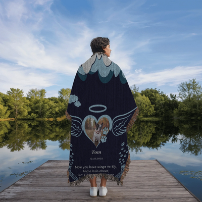 Personalized pet memorial woven blanket with angel wings, halo, photo, name, date, and remembrance poem on a navy background