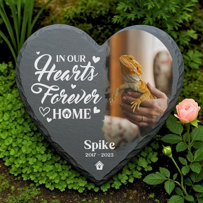 Personalized bearded dragon remembrance stone with engraved quote and custom lizard photo, resting among green plants and a pink rose.