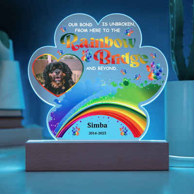 Paw-shaped acrylic LED light featuring a pet photo and the text "Our Bond Is Unbroken from Here to the Rainbow Bridge," perfect as a heartfelt pet memorial