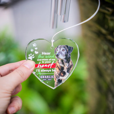 Hand holding heart-shaped glass wind chime with custom pet image, showing size and beveled glass edges