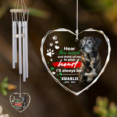 Heart-shaped glass ornament wind chime personalized with a dog photo and memorial quote, hanging outdoors in sunlight