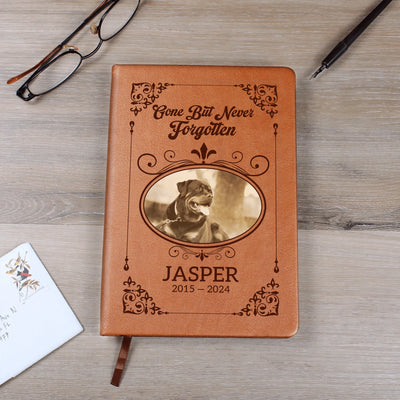 Flat lay of personalized pet memorial journal with custom photo and name on cover