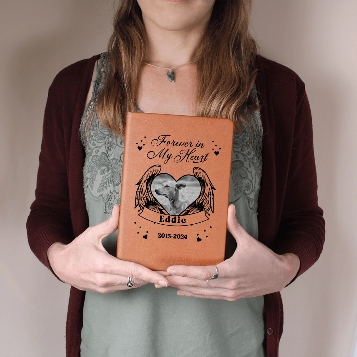 Woman holding personalized ‘Forever in My Heart’ vegan-leather pet memorial journal