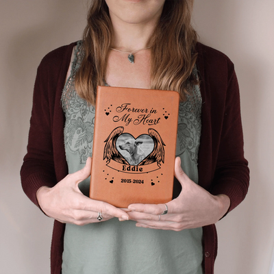 Woman holding personalized ‘Forever in My Heart’ vegan-leather pet memorial journal