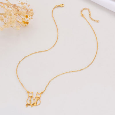 Gold necklace with cat-shaped pendant on a light background