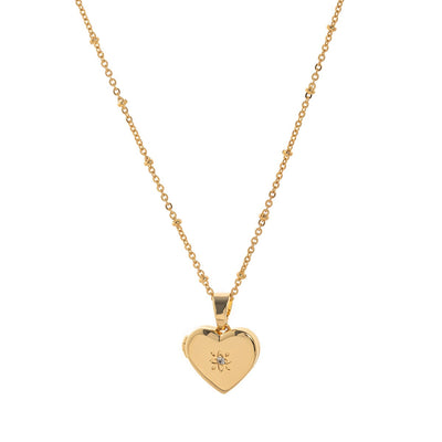 Gold heart-shaped pendant necklace on a white background