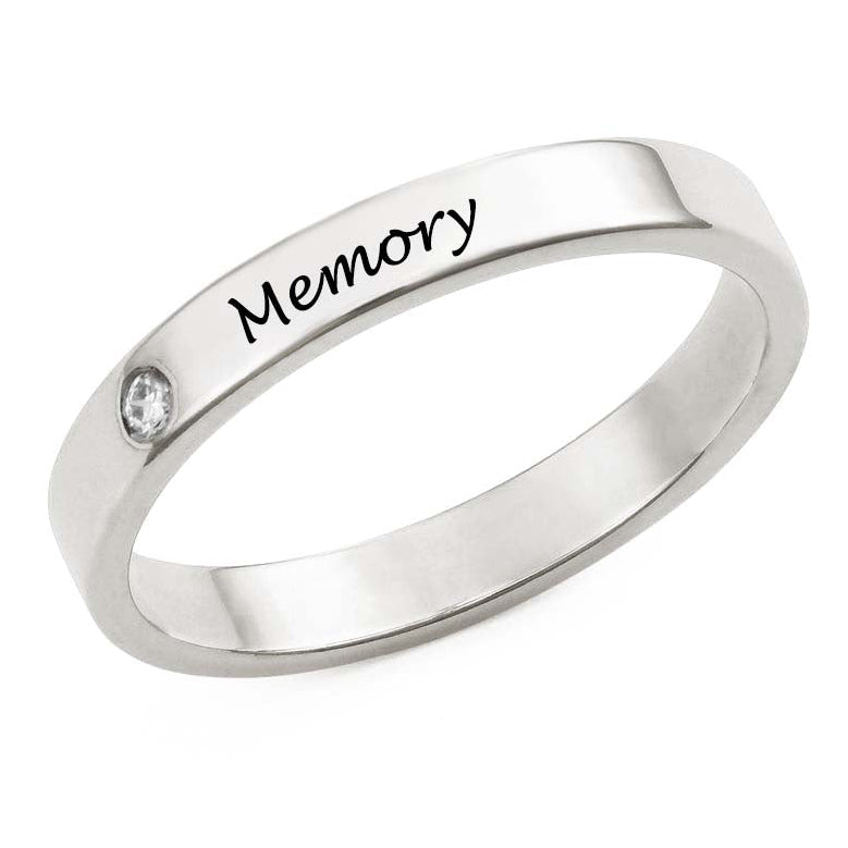 Silver ring with 'Memory' engraving on a white background