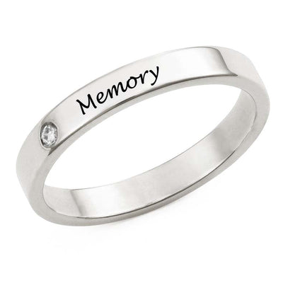Silver ring with 'Memory' engraving on a white background