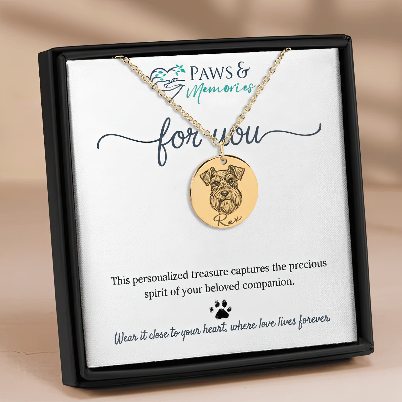 Gold necklace with a dog pendant on a 'Paws & Memories' card.