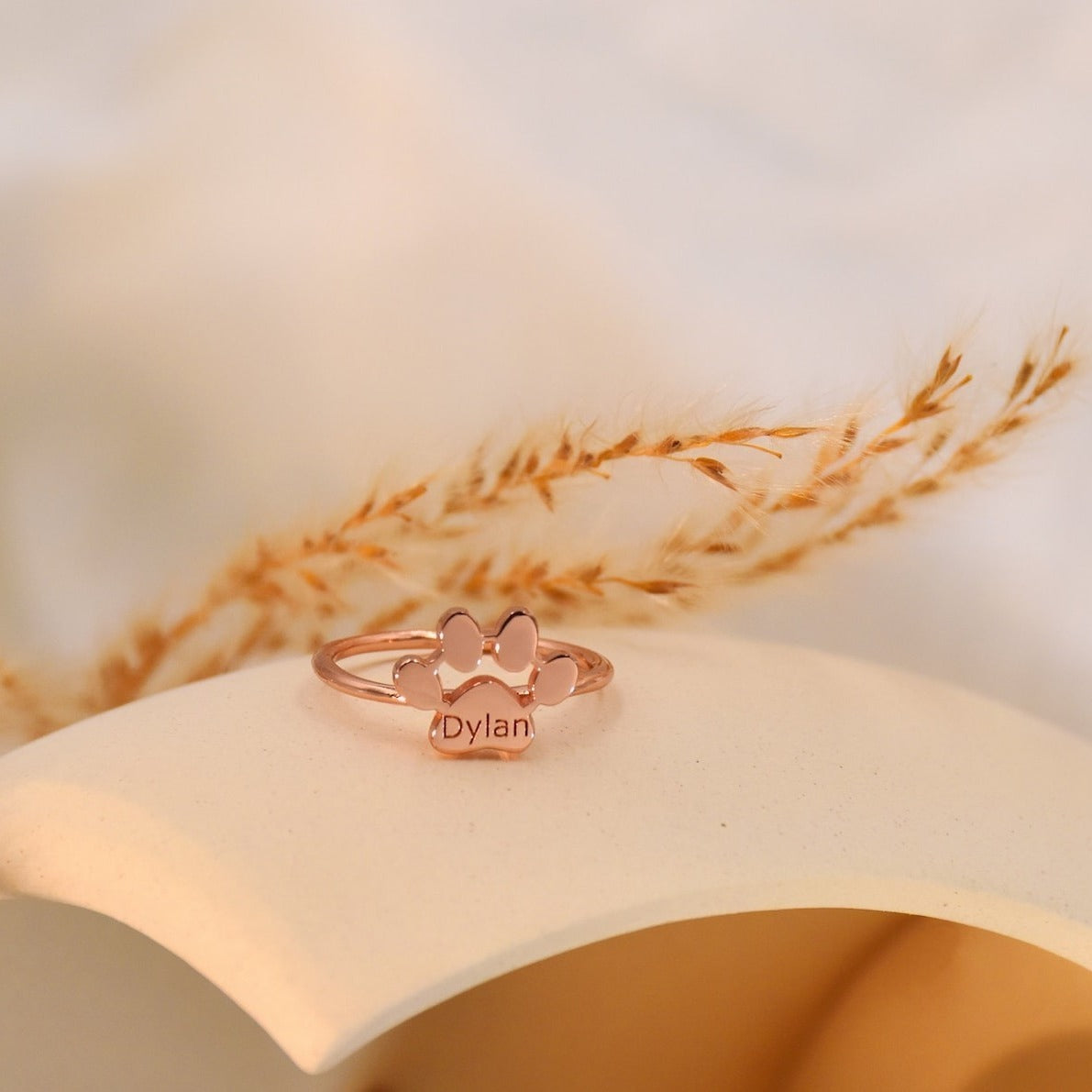 Rose gold ring with heart designs on a soft background