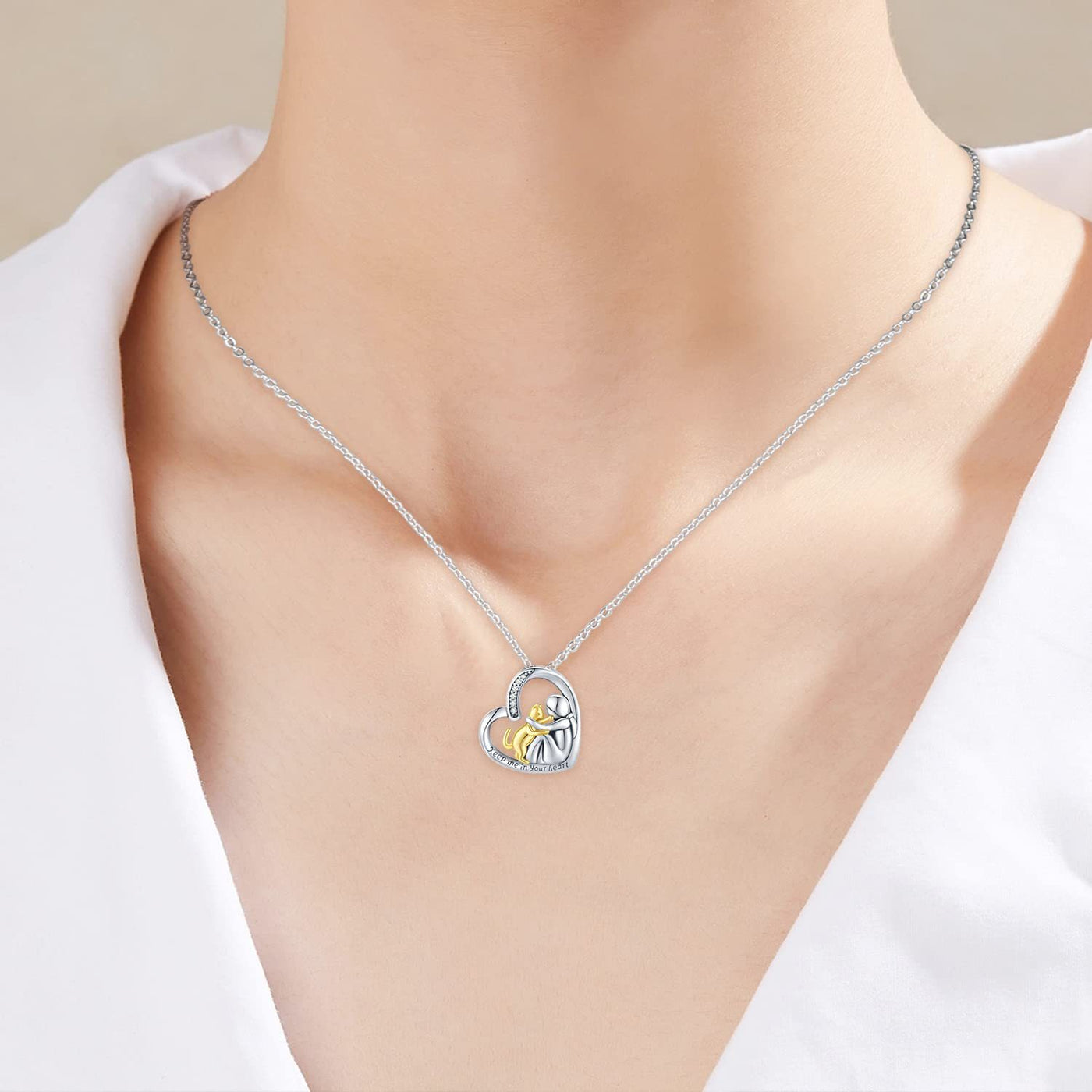 Silver necklace with a heart-shaped pendant on a white background