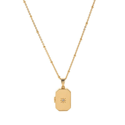 Gold necklace with a rectangular pendant on a white background