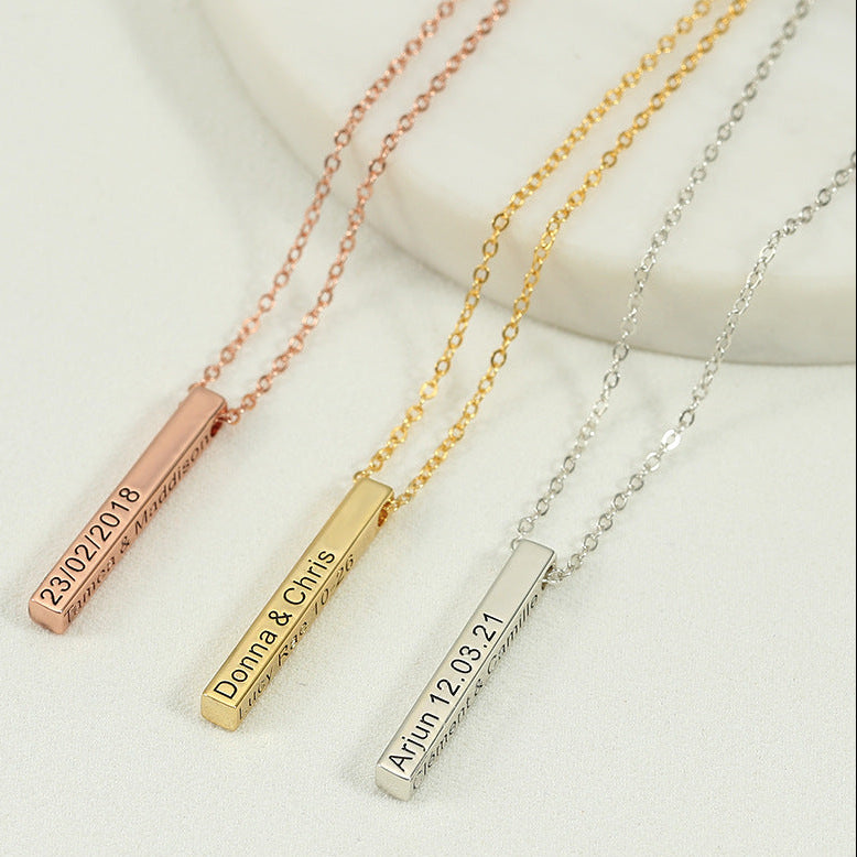 Three necklaces with engraved bars on a light background