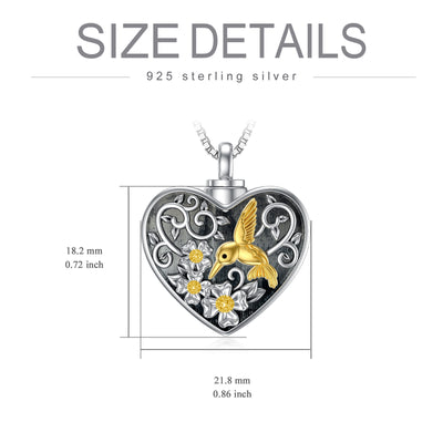 Heart-shaped pendant with a gold hummingbird design and measurements on a white background