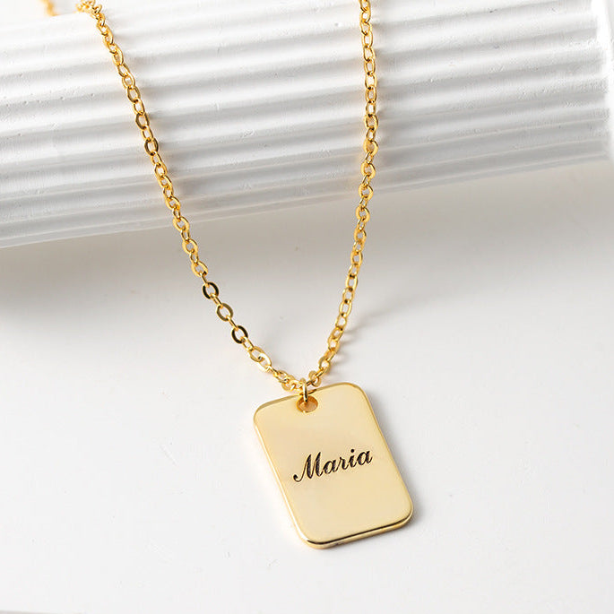 Gold necklace with a dog tag engraved with 'Maria' on a white background