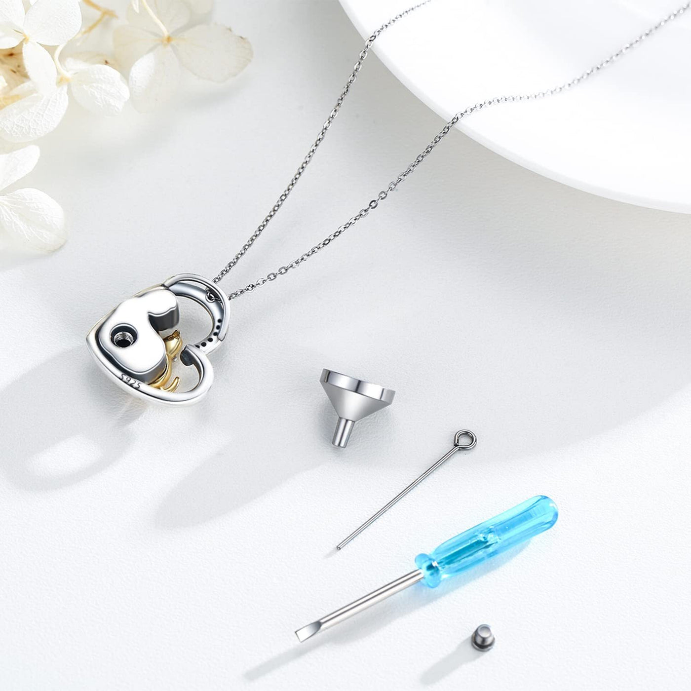 Jewelry cleaning kit with heart-shaped lock, funnel, and screwdriver on a white surface.