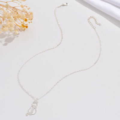 Silver necklace on a light background with dried flowers