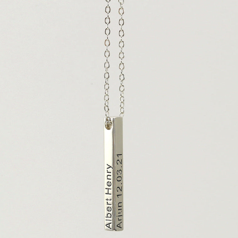 Silver necklace with a bar pendant on a light gray background