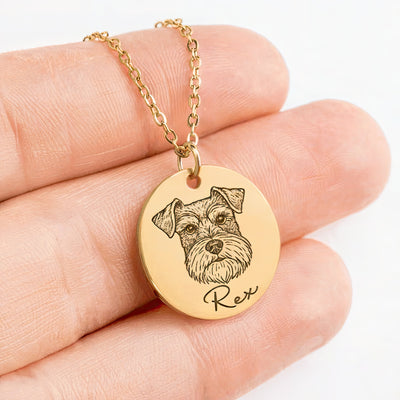 Gold necklace with a pendant featuring a dog's face and name 'Rex' held in a hand.